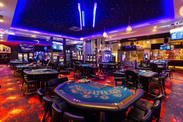 A glamorous woman holding casino chips in a neon-lit environment, representing the premium online casino atmosphere of JILI7979.