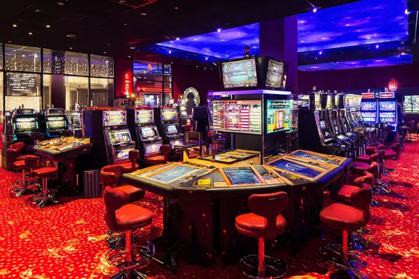 A professional dealer in a tuxedo greeting players at the roulette table, symbolizing the authentic live casino feel at JILI7979.