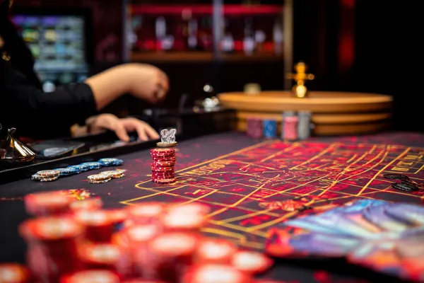 A glowing roulette wheel with cascading chips, symbolizing the engaging live and instant-win games available on JILI7979.