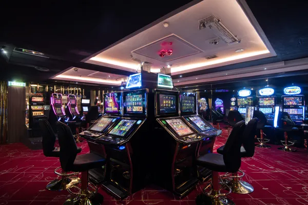 A person using their device against a moody casino-themed background, illustrating the smooth re-entry process at JILI7979.